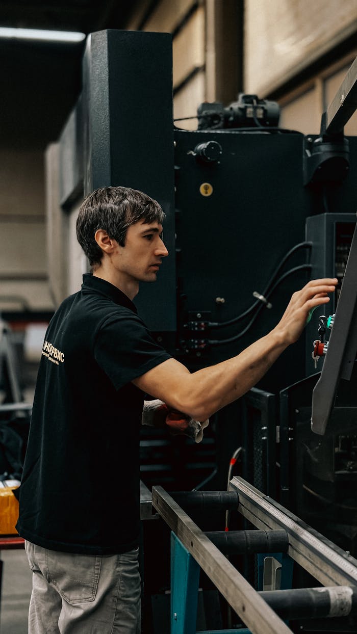 about-05 A focused worker operating heavy machinery in an industrial setting.