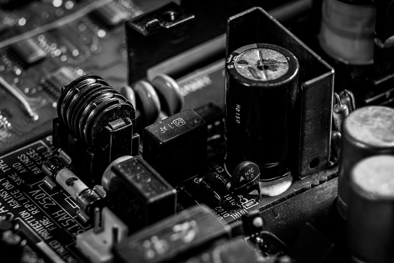 about-07 Detailed black and white image of electronic circuit board components for technology backgrounds.